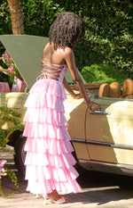 Rear view showing the pink strappy lace-up back and full tiered ruffle skirt of a maxi dress