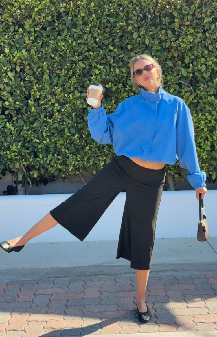 Black 3/4 length jersey pants with a wide leg and a fold-over waist detail