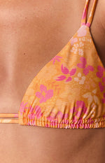 Close-up of the orange floral bikini top showing the ruched detail along the bottom edge of the cup