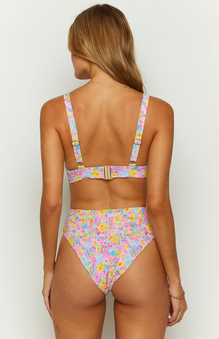 Rear view of the high-waisted bikini bottoms with a pink, yellow, and blue painted floral pattern