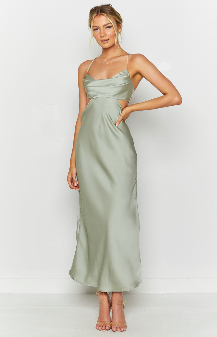 Sage green silky maxi dress with a draped cowl neckline, thin spaghetti straps, and side waist cutouts