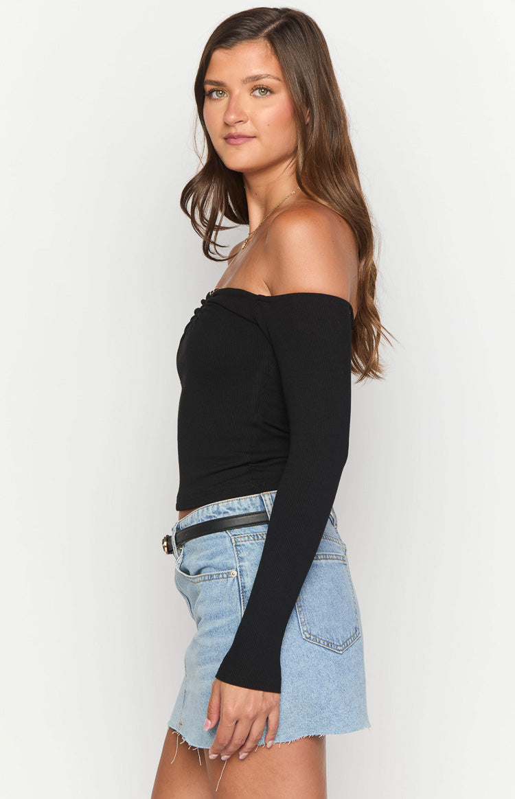 Side view of a black ribbed off-shoulder long sleeve top with ruched bust detail