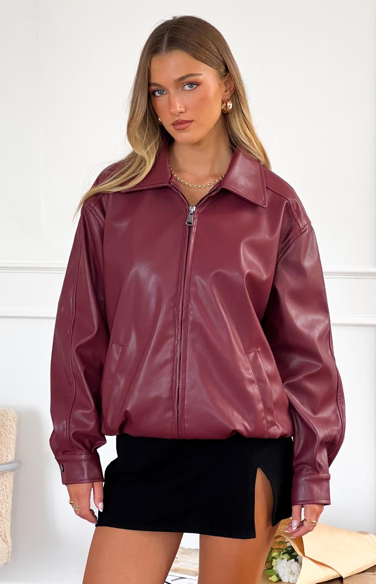 Front view of a red PU bomber jacket with a collared neckline, full zip front, and relaxed fit with elasticated hem