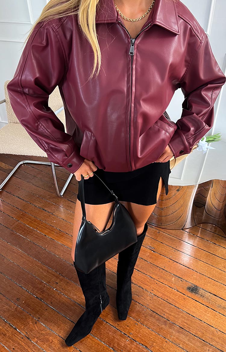 Front view of the red PU bomber jacket, showing the collared neckline, full-zip front, and buttoned cuffs