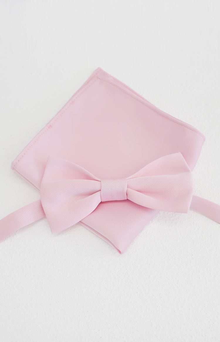 Close-up flat lay of a soft pink bow tie with a matching neatly folded pocket square