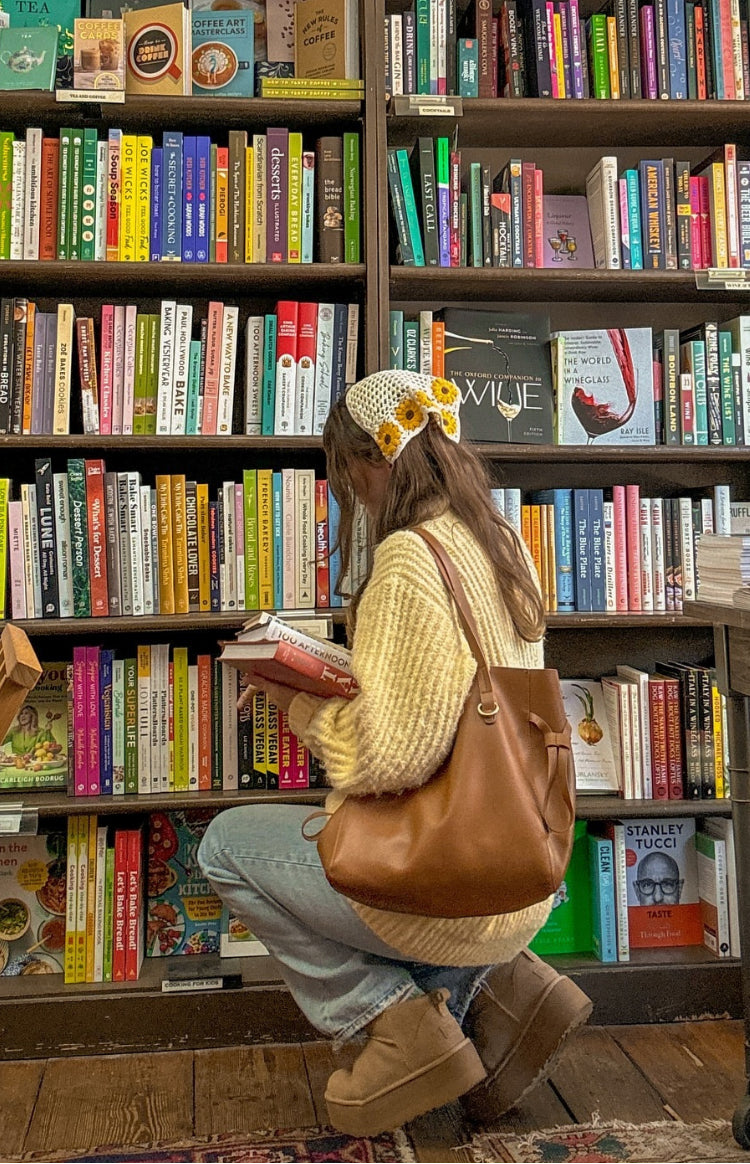 Side and back view of a yellow oversized chunky knit sweater with long sleeves and a relaxed fit