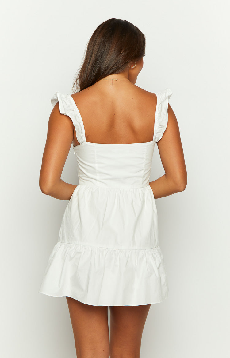 Rear view of a white mini dress with a square back and ruffled shoulder straps, tiered skirt