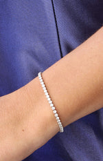 Close-up of a silver diamante tennis bracelet with a continuous line of sparkling stones