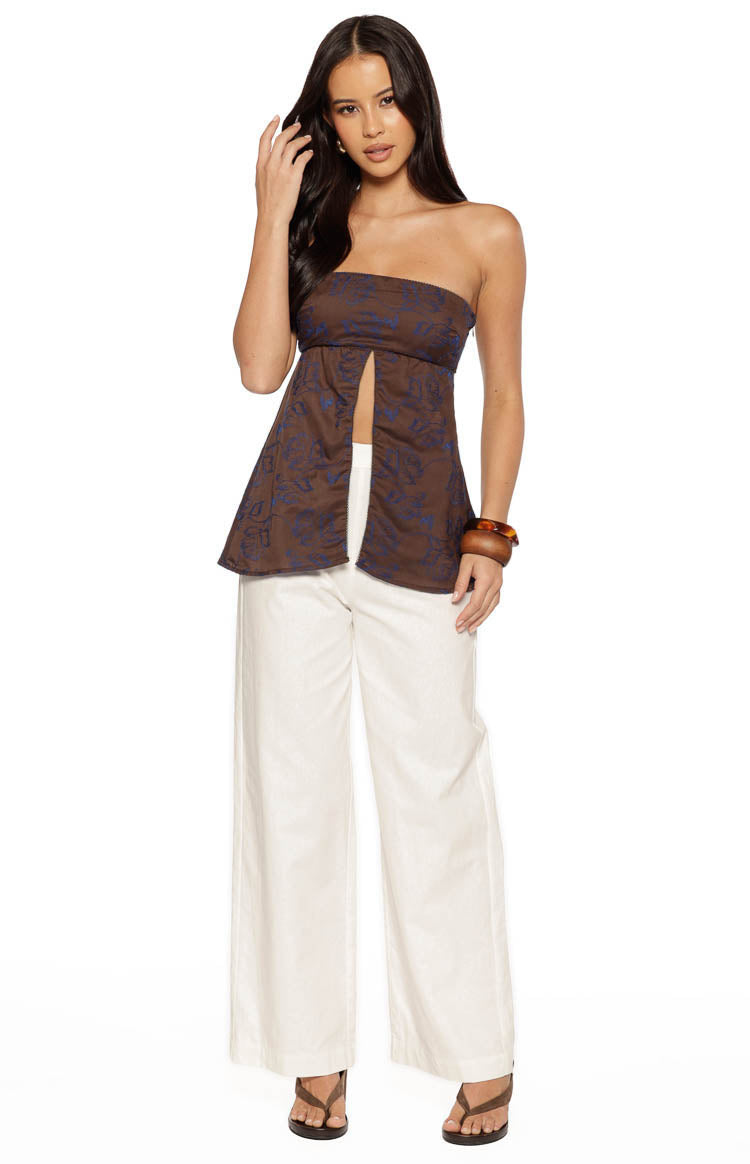 Brown strapless longline top with blue floral print and a split front design that flares out