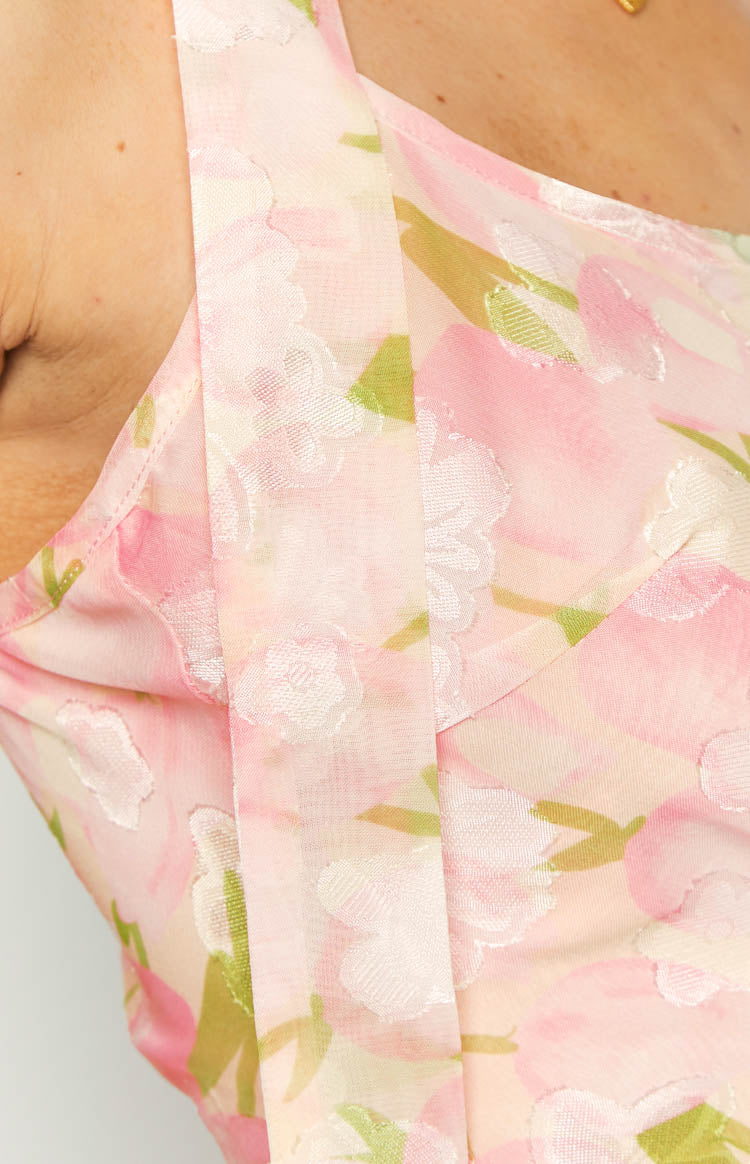Close-up of the pink floral print cami top showing the textured fabric and shoulder strap