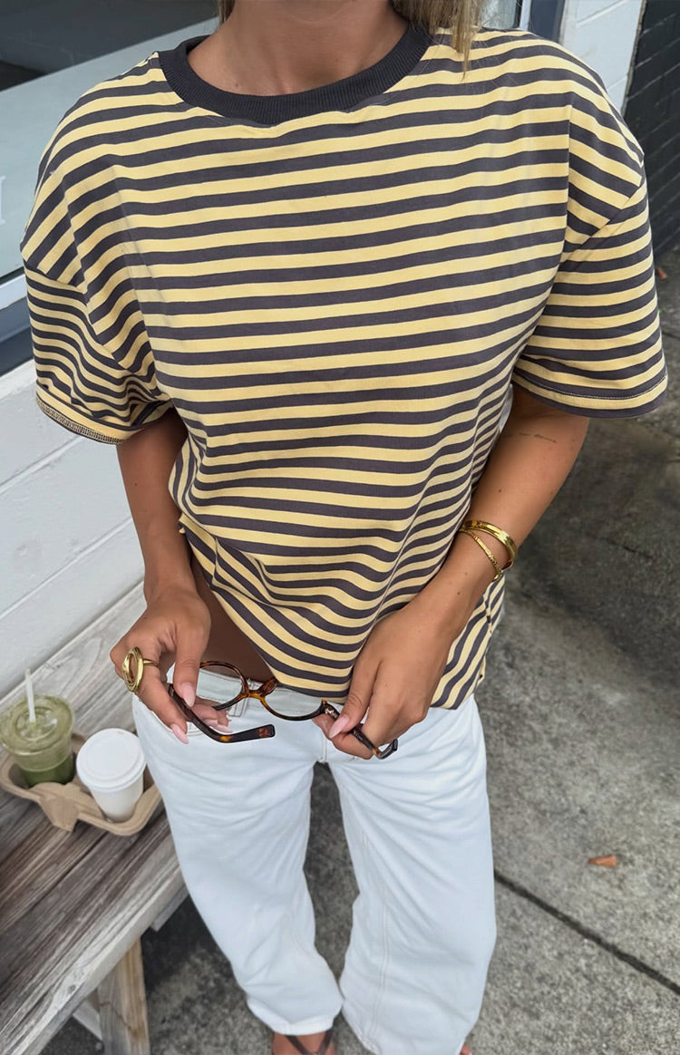 Yellow and charcoal striped oversized tee with a charcoal ribbed crew neck, showing its relaxed drape