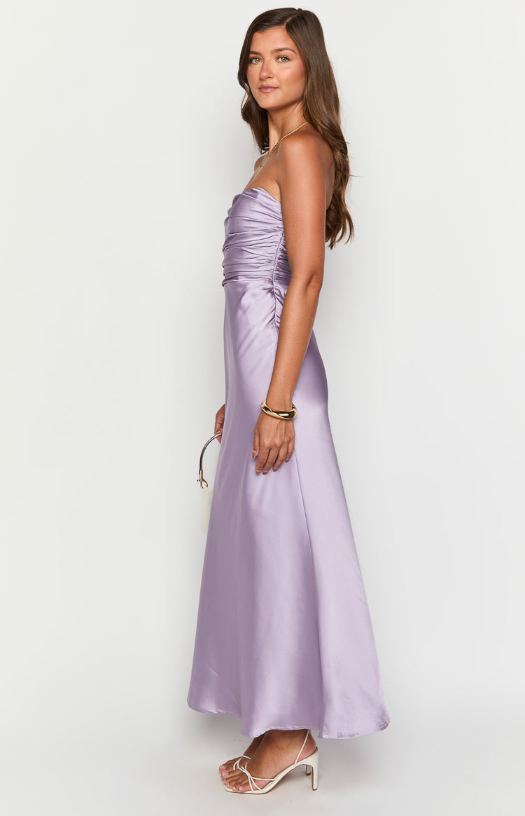 Side view of a purple strapless maxi dress showing the ruched bodice and flowing satin skirt