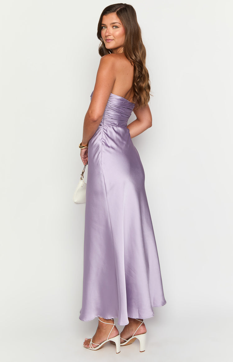 Side view of a purple satin strapless maxi dress with ruched bodice and flowing skirt