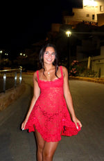 Red lace mini dress with a square neckline, thin straps, small bow detail, and a flowy ruffled hem