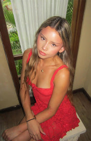 Red lace mini dress with a square neckline, thin straps, and a small pink bow detail at the bust