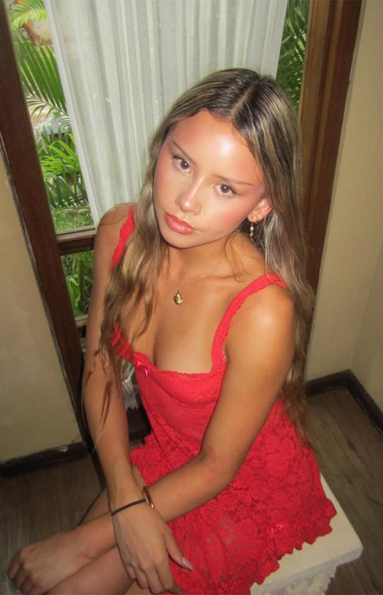 Red lace mini dress with a square neckline, thin straps, and a small pink bow detail at the bust