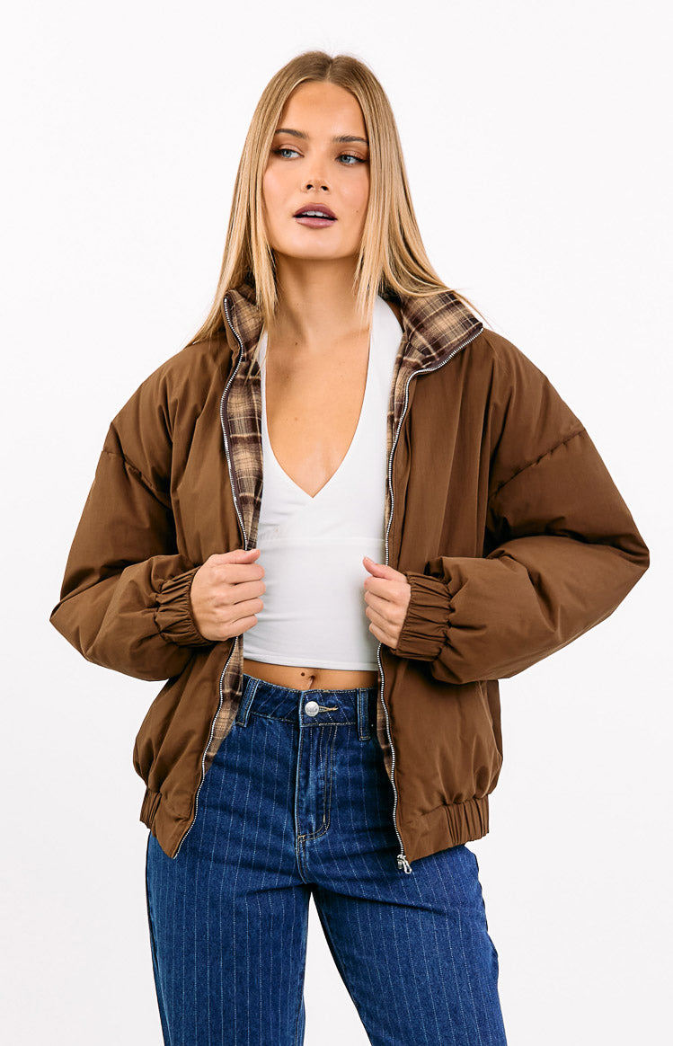 Open brown puffer jacket showing the brown and beige plaid lining on the collar and inside