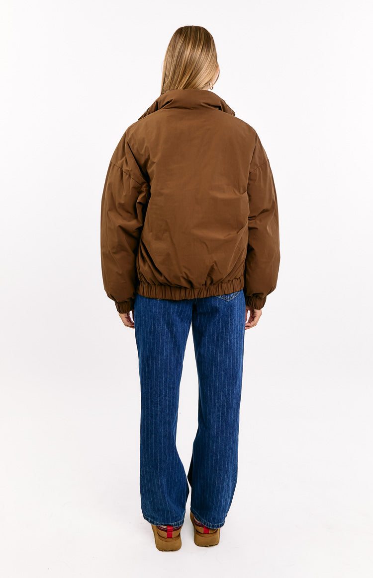 Back view of a brown puffer jacket with a high collar, relaxed fit, and elasticated hem