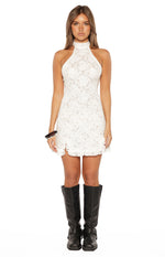 White floral lace mini dress with a high halter neckline, fitted bodycon silhouette, and a ruffled hem detail