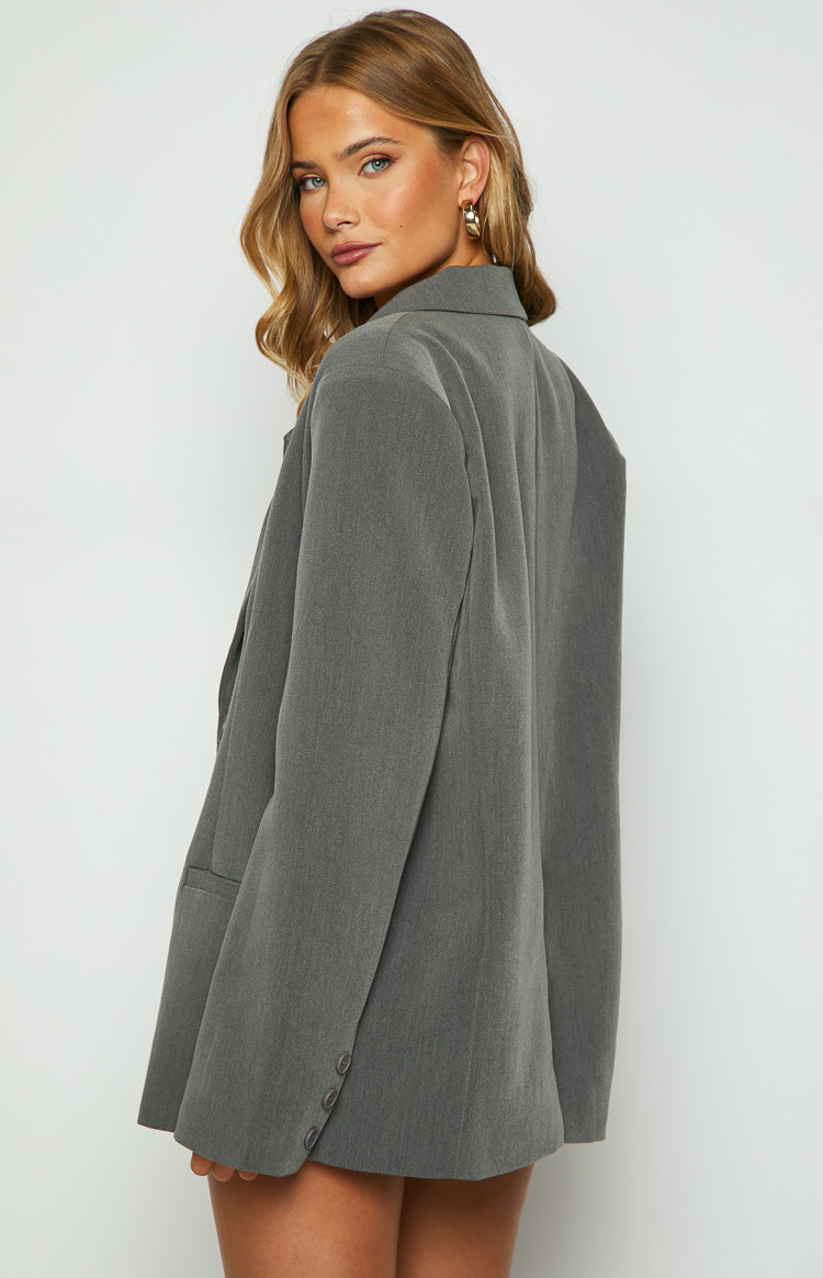 Side profile of a grey oversized blazer with a relaxed fit and three buttons on the sleeve cuff