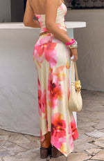 Side view of the yellow and pink floral print maxi skirt, showing the fitted silhouette and hanky hem