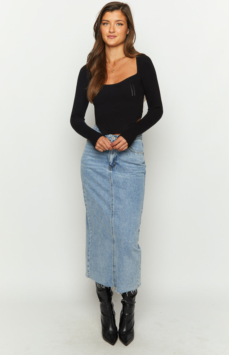 Front view of a black ribbed knit long sleeve top with a square neckline and waist cutout
