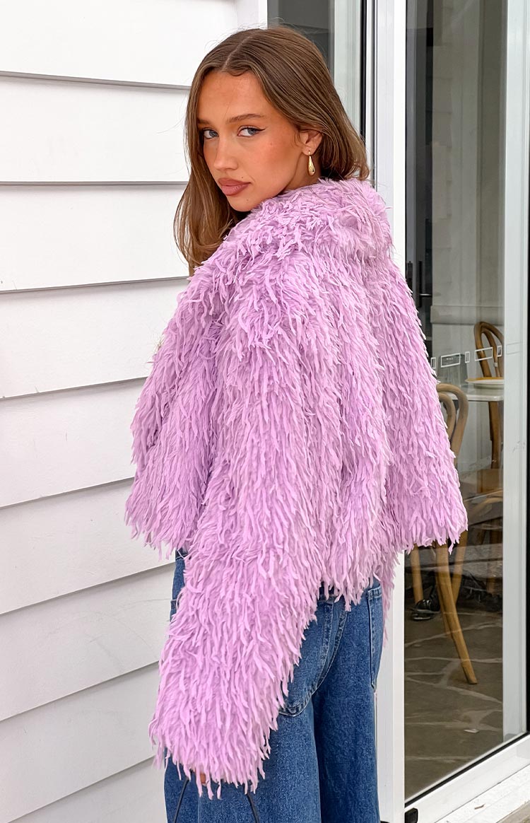 Side view of a cropped purple shaggy fringe jacket with long textured strands