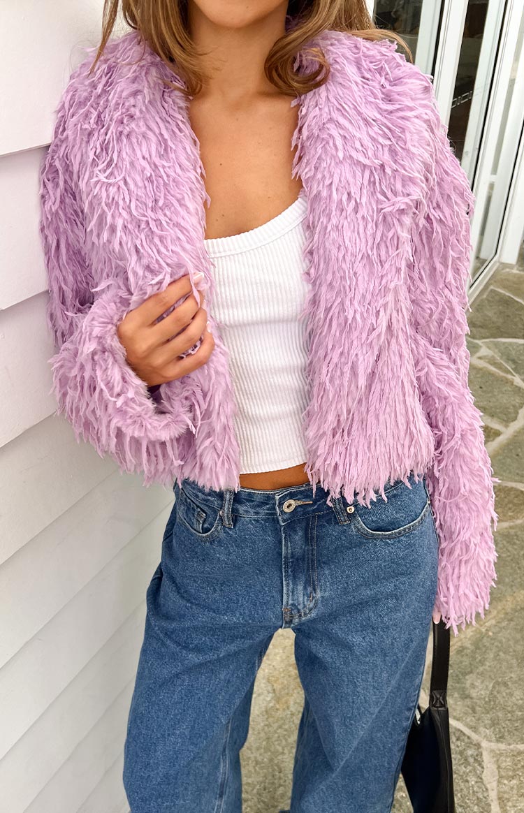Close-up of the shaggy purple fringe jacket worn open, showing the cropped length and textured material