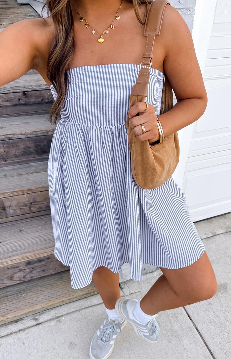 Close-up of the blue and white striped strapless mini dress showing the gathered elasticated waist and seersucker texture