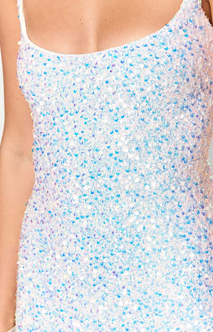 Close-up of the white sequin embellishment on the maxi dress, shimmering with iridescent blue and purple hues