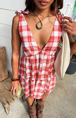 Red and white plaid print mini dress with deep V-neck, tie-shoulder straps, and tiered skirt