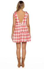 Rear view of a red and white plaid mini dress with a deep V-back and tie-shoulder straps