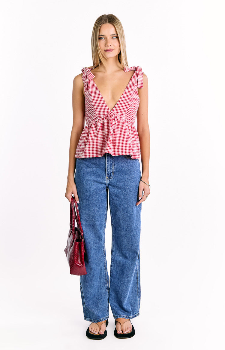 Red gingham tie top with a deep V-neckline and a gathered peplum hem