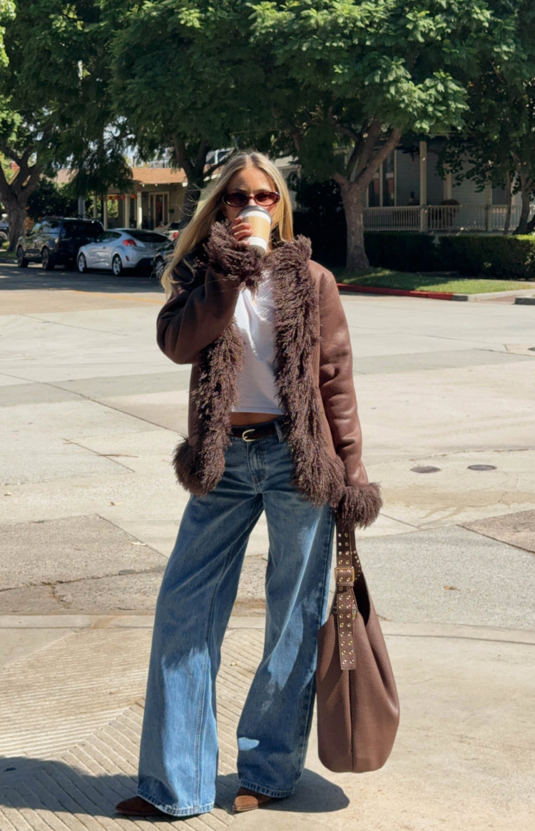 Brown cropped jacket with shaggy fur trim on the collar, cuffs, and down the open front