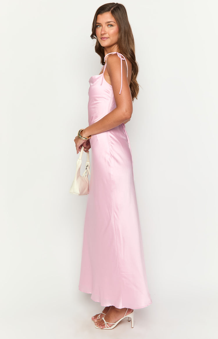 Side view of a pink satin maxi dress with a draped cowl neckline and delicate tie-shoulder straps