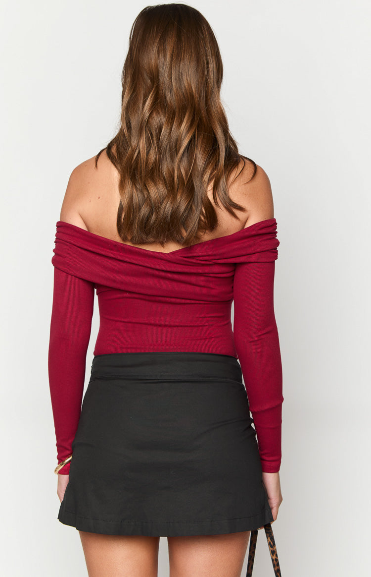 Rear view of a deep red ribbed knit off-shoulder bodysuit with long sleeves and a crossover detail at the back neckline