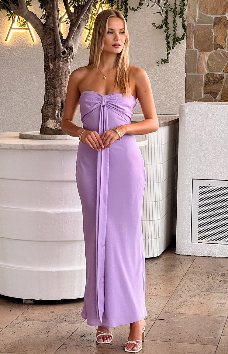 Full length front view of a lilac satin strapless maxi dress with a twisted bust and long front panel