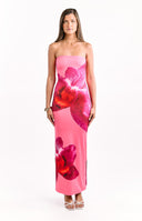 Model wears a pink and orchid floral strapless maxi dress perfect for a wedding guest.