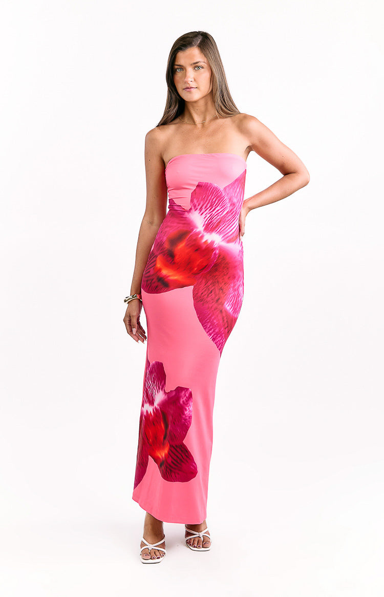 Front view of a pink strapless bodycon maxi dress featuring large fuchsia and red orchid prints