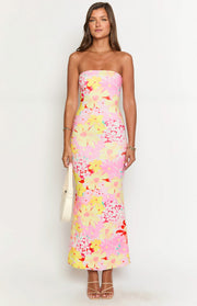 Front view of a pink, yellow, and red floral print strapless maxi dress with a fitted silhouette