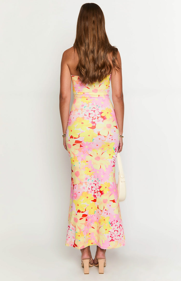 Rear view of a strapless yellow, pink, and red floral print bodycon maxi dress