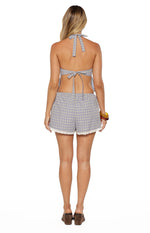 Rear view of blue and beige plaid shorts with an elasticated waist and white lace trim along the hem