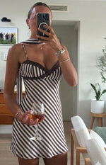 Sweetheart neckline of a brown and white diagonal stripe micro mini dress with thin straps and scarf