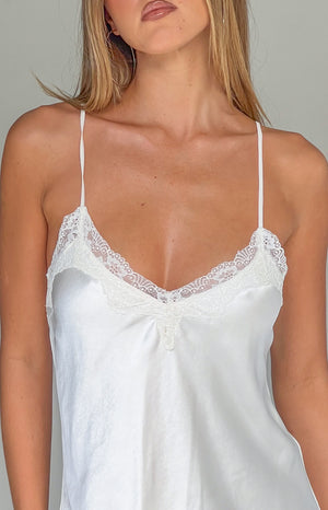 Close-up of the cream satin V-neckline with delicate lace trim and thin spaghetti straps
