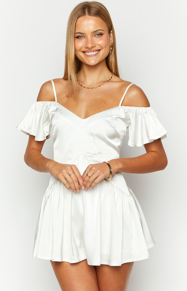 Front view of a white satin playsuit with a V-neckline, off-shoulder ruffled sleeves, and thin spaghetti straps