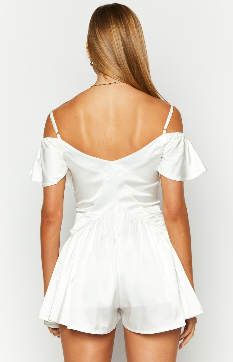 Rear view of a white satin playsuit with off-shoulder flutter sleeves and a gathered waist