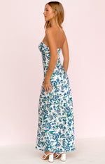 Side view of the white floral maxi dress with a strapless sweetheart neckline and flowing skirt