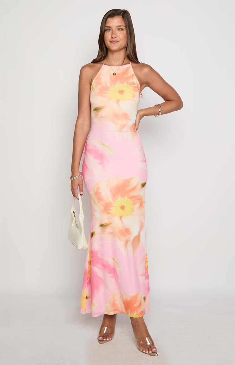 Full length view of a pink floral maxi dress with a halter neckline and bodycon fit