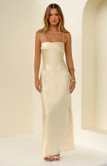 Pale yellow satin maxi dress with a straight neckline and thin spaghetti straps