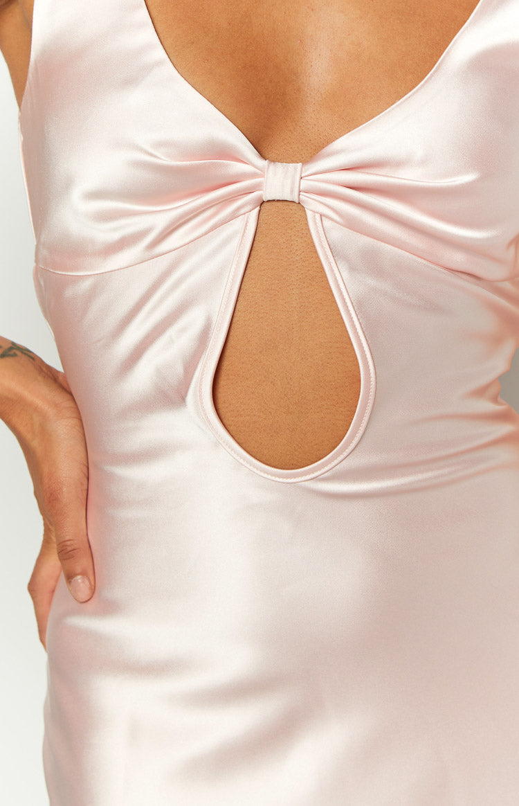 Close-up of the pink satin bow detail and teardrop cutout on the bodice of a maxi dress